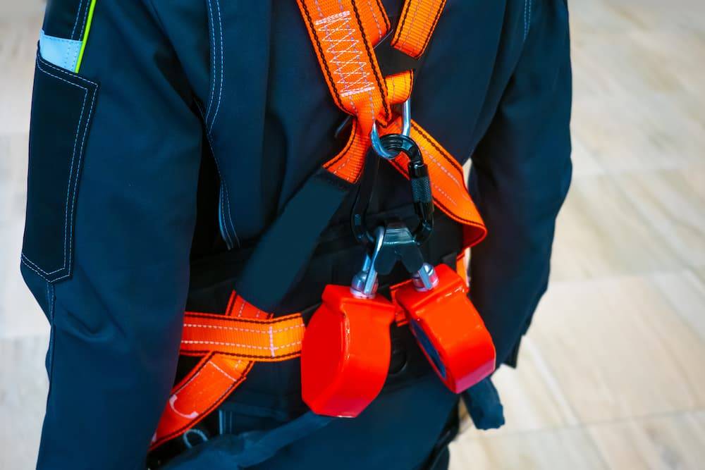 Construction Worker With Harness On Back